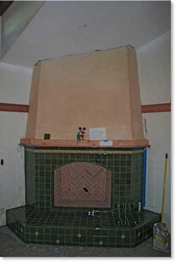 Master bedroom fireplace covered in Batchelder tile.