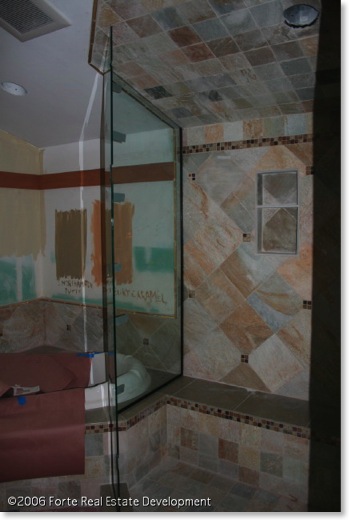 Master bathroom is tiled in glass, slate, and seagrass limestone.