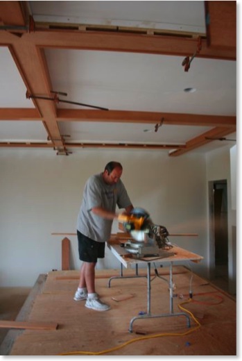 Dave Barlow installs the living room beams