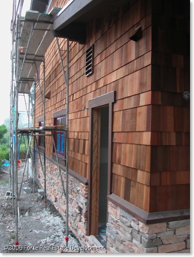 Craftsman shingle and stone siding is installed.