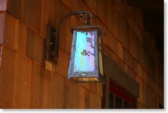 Craftsman wall sconce with an oak filigree