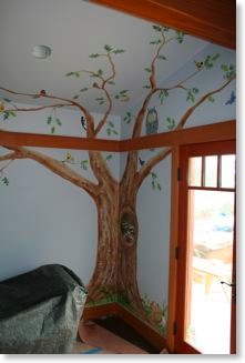 Mural of an oak tree with animals in the girls' bedroom.